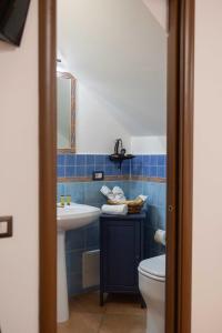 a bathroom with a sink and a toilet at Dalì alla rocca in Cefalù +32 photos