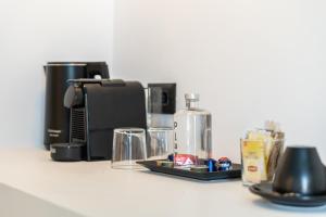 a counter with a coffee maker and other items on it at Play Paros in Kampos Paros