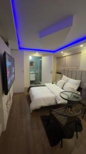 a bedroom with a large bed and a tv at Made Stays in Johannesburg +19 photos