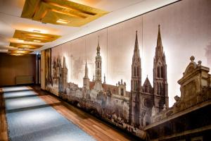 a hallway with a mural on the wall at Motel One Prague-Florentinum in Prague