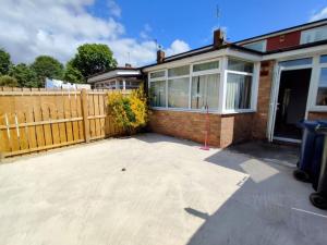 a home with a wooden fence and a patio at Sigma Haven, Free Parking in Old Walker