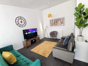a living room with a couch and a tv at Sigma Haven, Free Parking in Old Walker