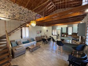 a living room with a couch and a dining room at Casa Spiladia in Chios
