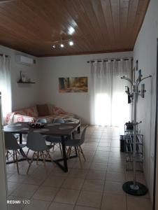a living room with a table and a couch at Sunray Separate Villa in Skala Sotiros