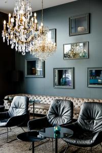 a dining room with chairs and a chandelier at Motel One Prague-Florentinum in Prague