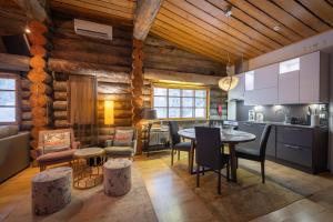 a kitchen and dining room with a table and chairs at Kuukkeli Log Houses Teerenpesä - Superior Suite A49 in Saariselka