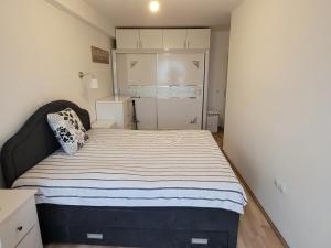 a bedroom with a bed and a refrigerator in it at Florida Apartment in Gevgelija