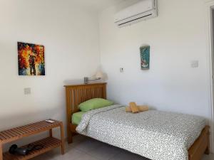 a bedroom with a bed and a painting on the wall at Central 2 Bedroom Apartment Pafia 2 in Paphos