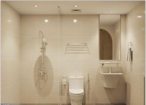 a bathroom with a shower and a toilet and a sink at Grand Central Hotel- Vinhomes Ocean Park 3 in Ðình Loan