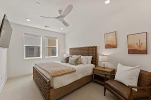 a bedroom with a bed and a ceiling fan at Periwinkle Sky condo in St. George