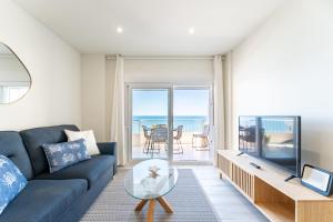 a living room with a blue couch and a glass table at Amazing Rey de España Views in Fuengirola
