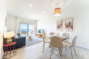 a living room with a table and a dining room at Amazing Rey de España Views in Fuengirola