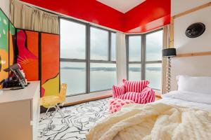 a bedroom with a bed and a desk and windows at Danga Bay Country Garden by Short Escape in Johor Bahru +119 photos