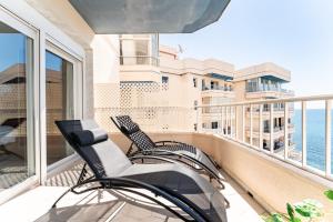 a balcony with two chairs and a view of the ocean at Amazing Rey de España Views in Fuengirola