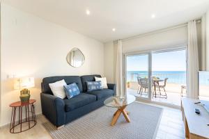 a living room with a couch and a view of the ocean at Amazing Rey de España Views in Fuengirola
