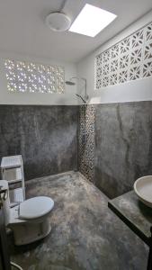 a bathroom with a toilet and a sink at NEW The Loft - Uluwatu Surf Ranch in Uluwatu