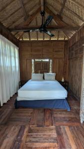 a bedroom with a bed in a wooden room at NEW The Loft - Uluwatu Surf Ranch in Uluwatu