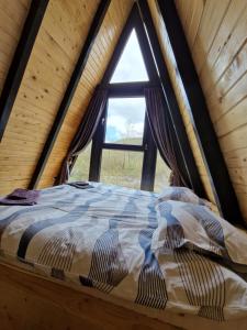 a bed in a room with a window at A-Park Bologa in Bologa