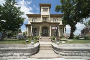 a large house with a staircase in front of it at The Pepin Mansion B&B on Mansion Row - 10 min to start of the Bourbon Trail in New Albany