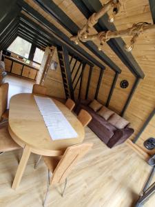 a wooden table and chairs in a room at A-Park Bologa in Bologa