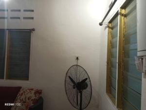 a fan hanging on a wall in a room at Dian in Muadzam Shah
