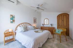 a bedroom with a bed and a dresser at Sea Whisper Home -Sunset, Sea, Easy Stay, Shops in Praiano