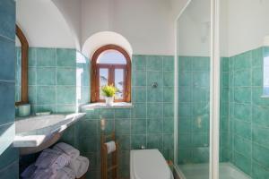 a bathroom with a tub and a sink and a toilet at Sea Whisper Home -Sunset, Sea, Easy Stay, Shops in Praiano +82 photos
