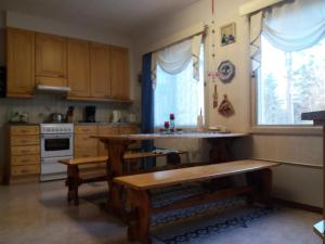 a kitchen with wooden cabinets and a table and a window at Apartment Sorsakoski in Sorsakoski