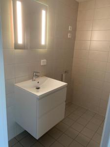 a white bathroom with a sink and a mirror at Bedroom&ensuite in Moss