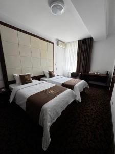 a hotel room with two beds in a room at SK Hotel in Bishkek