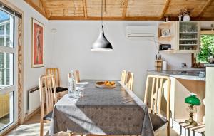 a dining room with a table and a kitchen at Lovely Home In Børkop With Wifi in Børkop +9 photos