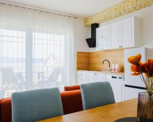 a kitchen with a table and chairs and a refrigerator at Apartments in Villa Azur in Novi Vinodolski +49 photos