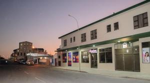 an empty city street at night with a building at The View Apartment 2 in Lüderitz