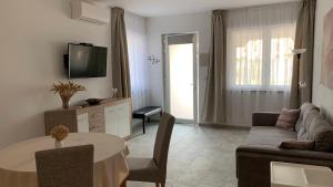 a living room with a couch and a table at Balatonföldvár Centrum Apartmanok 3 in Balatonföldvár