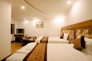 Postel nebo postele na pokoji v ubytování A9 Beach Hotel Da Nang