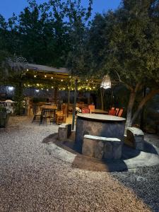 a patio with a table and chairs and lights at Cortijo Loma del Estanque in Monachil