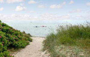 a boat in the water with a person in it at 3 Bedroom Amazing Home In Sydals in Østerby +16 photos