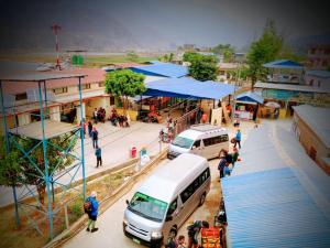 a group of people standing at a bus station at B N Hotel & Restaurant in Rāmechhāp