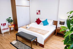 a small bedroom with a bed and a chair at Hanoi Nest Seekers -New Branding - WestLake view Building in Hanoi
