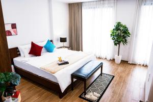 a bedroom with a bed with a table and a plant at Hanoi Nest Seekers -New Branding - WestLake view Building in Hanoi