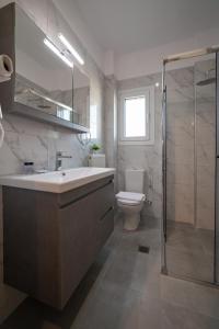 a bathroom with a sink and a toilet and a shower at Pantheon Suites Fasianos in Nafplio +29 photos