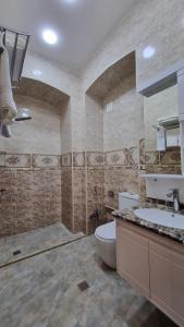 a large bathroom with a toilet and a sink at Grandview Boutique Hotel in Baku