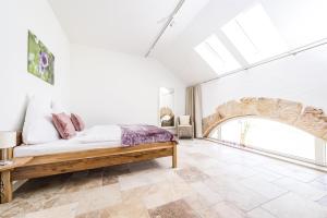 a bedroom with a bed and a large window at Hofgut Dösterhof - Hotelzimmer in Wadern