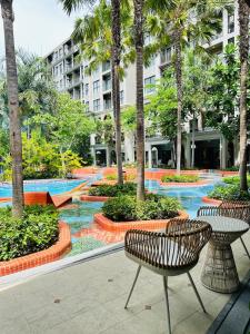 a courtyard with two chairs and trees in a building at Joy house 1 bedroom Lahabana HuaHin in Hua Hin +59 photos