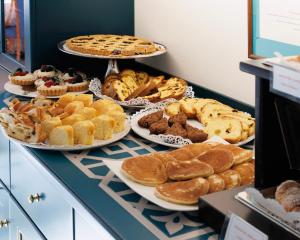 a buffet filled with different types of pastries and pies at Hotel Villa Adriana in Monterosso al Mare