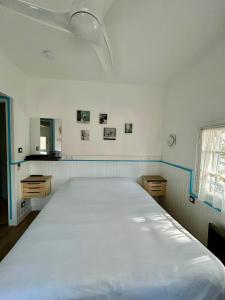 a bedroom with a large white bed in it at Hotel Oasis in Argelès-sur-Mer