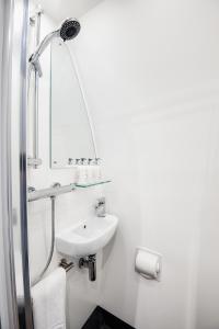 a white bathroom with a sink and a mirror at Peel Farm in Craighall