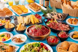a table filled with different types of food on plates at Shinjuku Washington Hotel in Tokyo