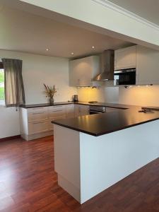 a kitchen with a black and white counter top at Seljesanden Apartment in Selje +27 photos