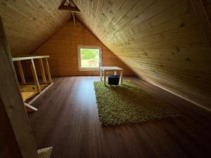 an attic room with a table and a window at Na Piaskach Agroturystyka Domek pod Lipą in Narol +9 photos